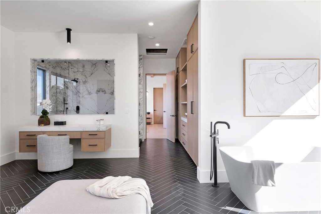 Completed bathroom remodel with freestanding tub and herringbone tile floor by Hillstar Construction in Los Angeles
