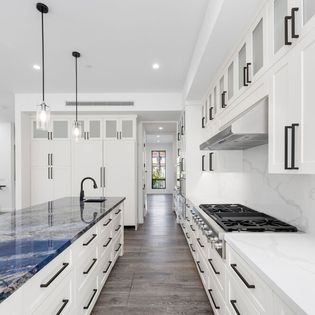 Galley kitchen remodel with marble countertops by Hillstar Construction in Los Angeles